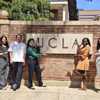 UCLA school sign with the research team, including PI and staff.