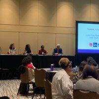 Image shows Dr. Everett take part of a panel at a conference.