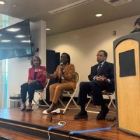 Dr. Everett speaking at the Delta Sigma Theta Sorority, Inc Community Health & Diabetes Education Event in Riverside, CA. She is sitting with two other individuals attending the event.